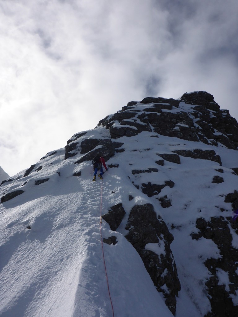 Approaching the little tower. After moving together on the easier ground below, we belayed on the rock above where I'm standing, and climbed two enjoyable pitches on mixed ground to the top of the little tower.