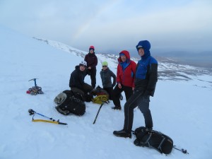 Jen consuming pasty in between ice axe arrest practice. Watched by Jenny, Nathan, Keith and Steve